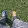Mann steht mit einem blauen und einem gelben Schuh auf einer Wiese - zur Veranschaulichung eines A/B-Test